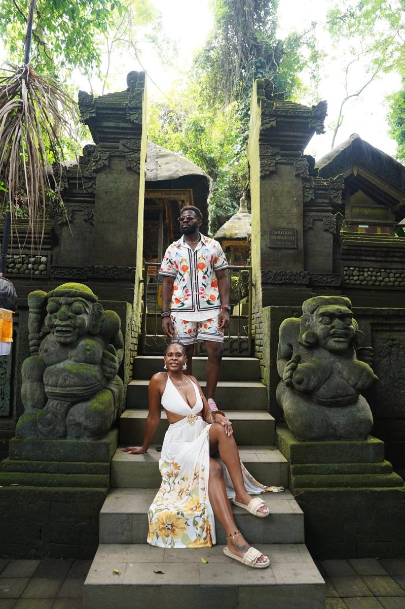 Amstrong standing above Kayla at a temple gate