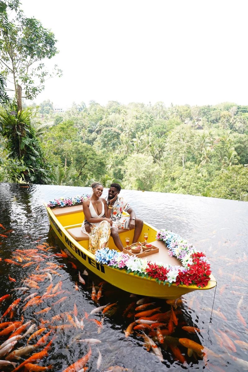 The couple in a flower boat on a koi pond