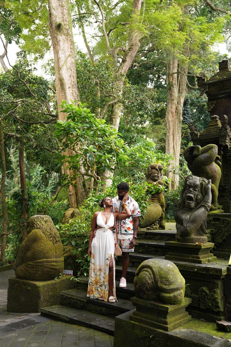 The couple beneath towering trees