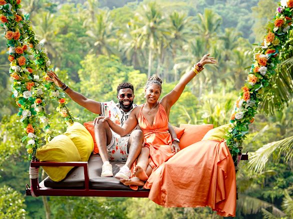 Kayla and Amstrong on a flower-garlanded jungle swing